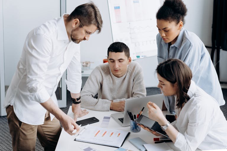 A group of professionals brainstorming and working together in a contemporary office setting.